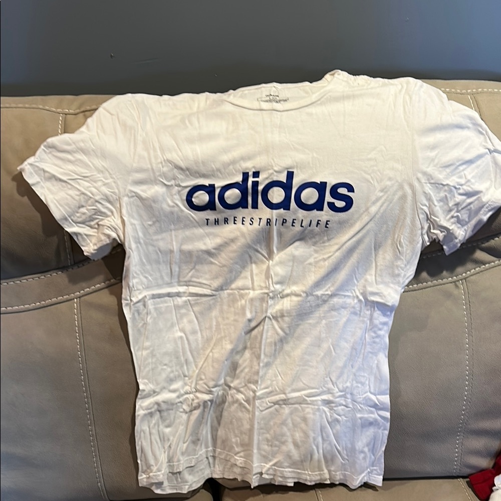 Adidas White Tee with Blue Logo. Says Large but fits like a Small-Medium